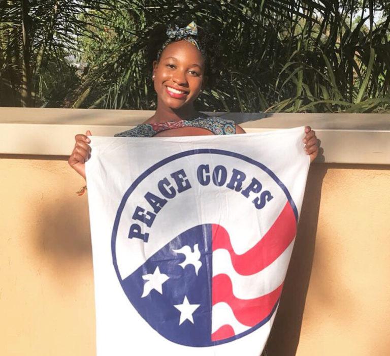 Kayla holding the peace corps flag